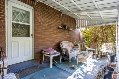 Covered porch on the side with entry into the kitc