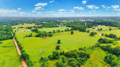 Aerial view of sparsely populated area featuring a pastoral area