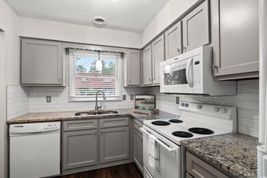 Kitchen featuring tasteful backsplash, dark hardwo