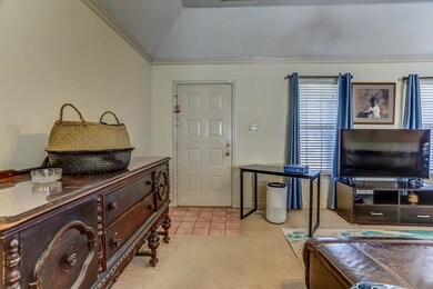 Carpeted foyer with a textured ceiling, lofted cei