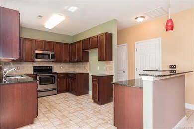 Kitchen with cherry cabinets, granite and breakfas