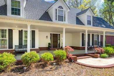 View of exterior entry with brick siding, covered 