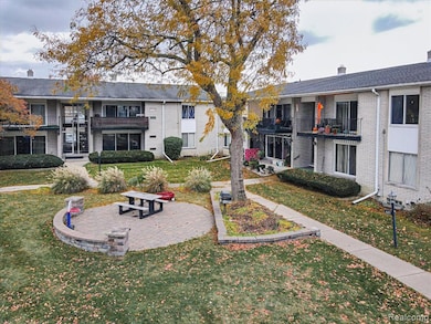 View of community featuring a lawn and a balcony