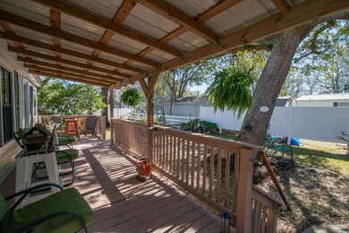 Wooden terrace with a fenced backyard