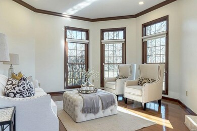 Cozy living room with large windows and tons of natural light.  Gleaming hardwood flooring throughout most of the main floor.