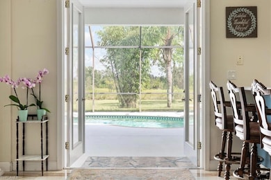 View of doorway leading to the inviting pool in the screened in lanai