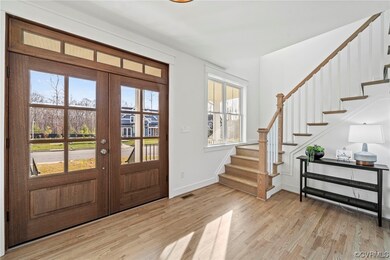 Foyer with french doors and light hardwood / wood-