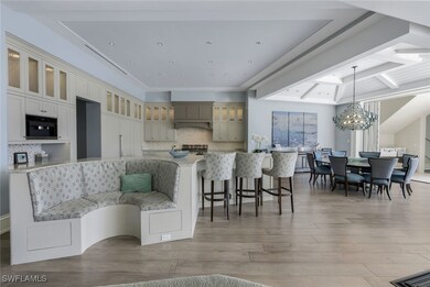 Kitchen with tasteful backsplash, glass insert cabinets, beamed ceiling, a kitchen bar, and light wood-style floors