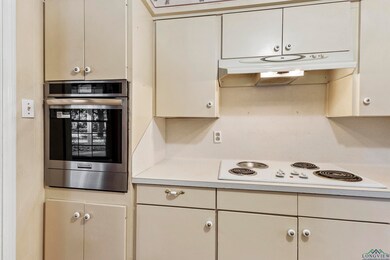 Kitchen with stainless steel oven and white electr