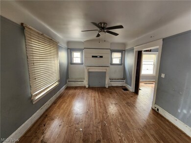Unfurnished living room with ceiling fan and hardwood / wood-style flooring
