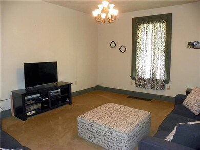 The spacious living room, with high ceiling and ne