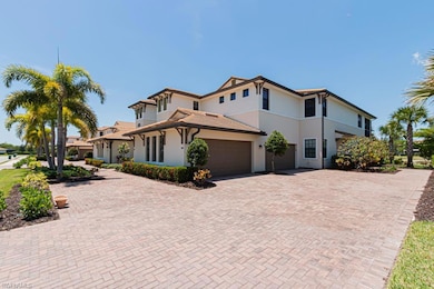 View of front of house featuring stucco siding, decorative driveway, and an attached garage