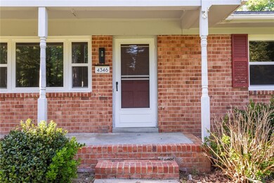 View of exterior entry featuring brick siding and