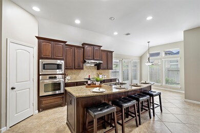 This kitchen features  granite countertop with fou
