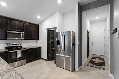 Kitchen with stainless steel appliances, light st