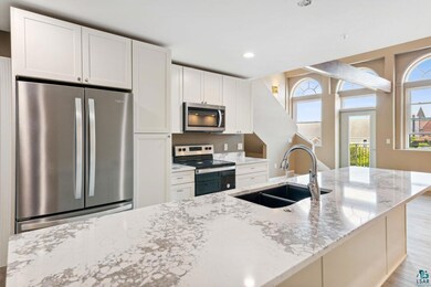 Kitchen featuring light wood-type flooring, applia