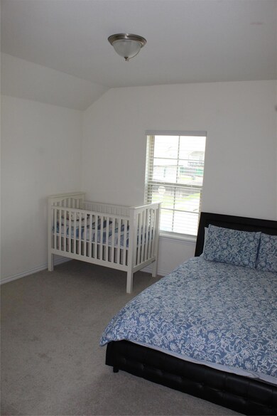 Bedroom featuring lofted ceiling, carpet floors, 