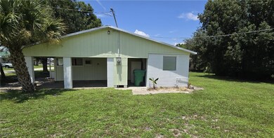 Rear view of property featuring a lawn