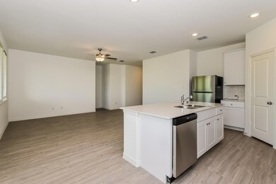Kitchen featuring an island with sink, white cabinetry, sink, and stainless steel appliances