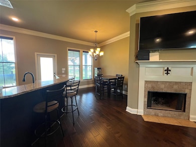 Kitchen featuring ornamental molding, a notable ch