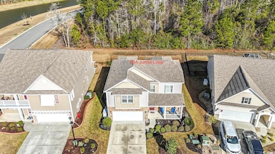 Birds eye view of property with a water view