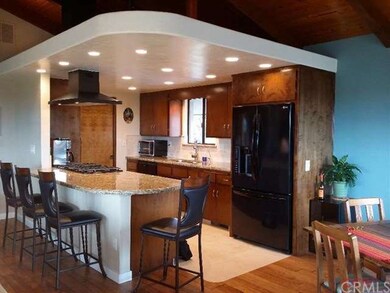 Custom kitchen with granite counter tops and trave