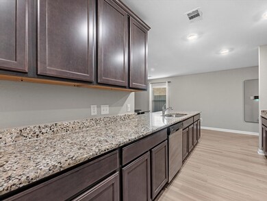 This kitchen has endless storage with plenty of countertop space and cabinets. Stainless steel appliances and fridge included.