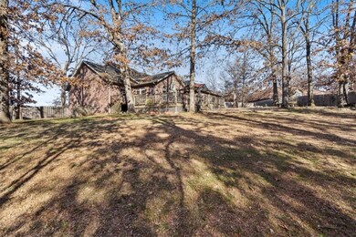 Looking from the grassy sloped side of the yard. and this ALL Brick Home.