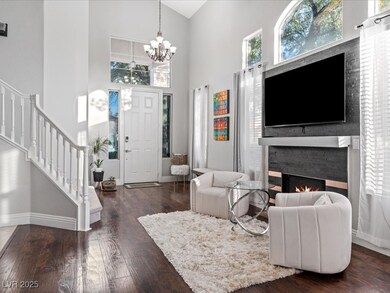 Living room with stairway, a warm lit fireplace, b