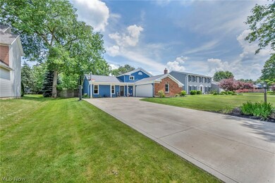View of front of home with a front lawn and a garage