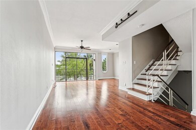 Living room overlooking balcony and tennis courts
