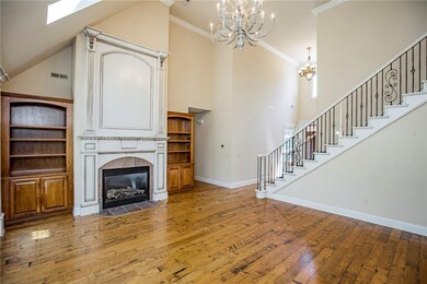 formal living room with soaring ceilings and gas fireplace