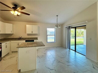 Kitchen with a kitchen island, lofted ceiling, dec