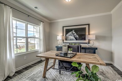 Office space featuring wood finished floors, baseboards, and ornamental molding