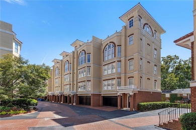 View of building exterior featuring a garage and driveway