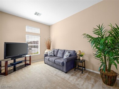 Living room with visible vents, carpet floors, and