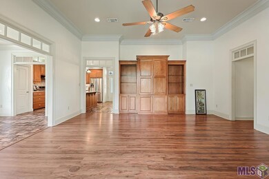 Great flowing floor plan. The Den has wood laminate flooring, transoms, canned lighting, ceiling fan and crown molding. The Den is open to the breakfast room and the formal Dining Area.