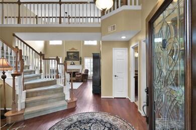 As you enter the leaded glass front door, you are greeted by this sweeping staircase and high ceilings!
