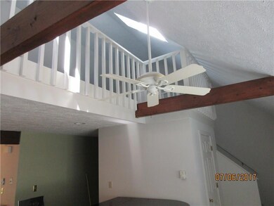 Living room with exposed beams and...