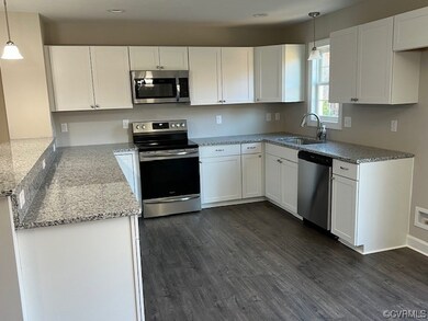 Kitchen featuring hanging light fixtures, sink, ap