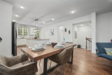 Dining area with wood finished floors and recessed lighting
