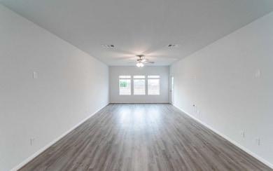 Unfurnished living room featuring baseboards, vis