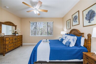 Primary bedroom with light carpet and ceiling fan