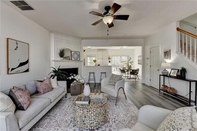 Living area featuring visible vents, a ceiling fan