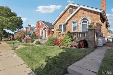 View of front facade with brick siding and a chimney