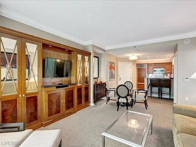 Living room with light carpet and ornamental moldi
