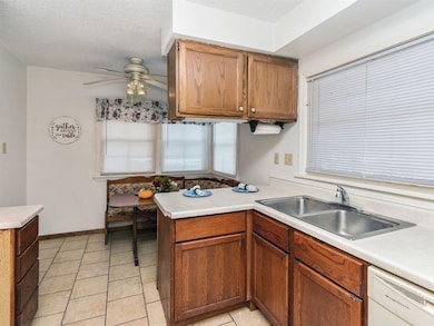 Cozy eat-in-kitchen with nook, tiled floor.