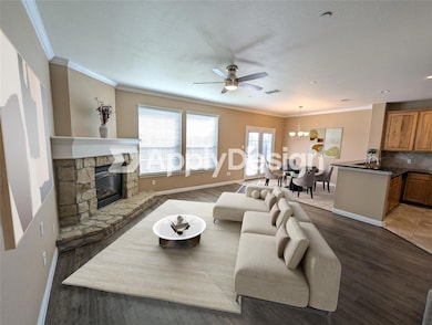 Living area featuring ornamental molding, a stone