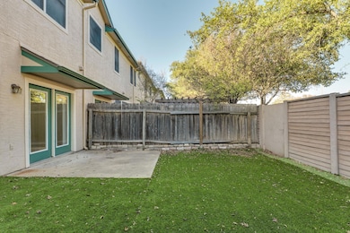 Fenced backyard with a patio