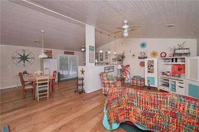 Dining area with ceiling fan, vaulted ceiling, woo